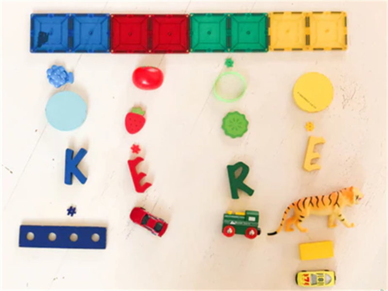  A close-up of colorful magnetic tiles being used to build a STEM structure, perfect for enhancing creativity and problem-solving.