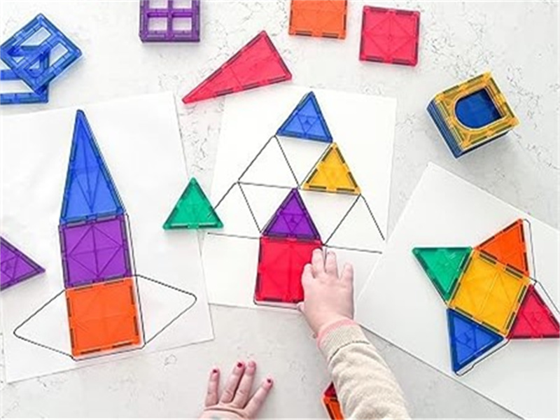 A set of magnetic tiles arranged on a table, illustrating their potential in STEM education and learning through play.