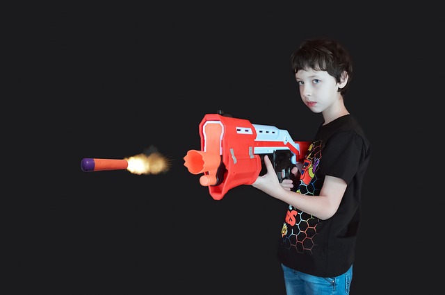 a boy playing with his soft bullet gun