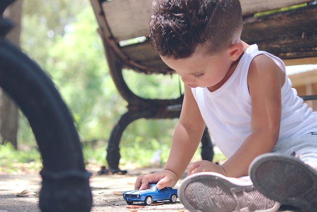 a boy playing with an electronic toy car